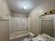 Bathroom featuring tub with shower, sink, and toilet at 380 Paper Mill Rd, Lawrenceville, GA 30046