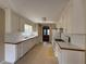 Spacious kitchen with white cabinets and appliances, next to a dining area at 380 Paper Mill Rd, Lawrenceville, GA 30046