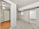 Carpeted basement area with an adjacent space with parquet flooring, separated by an open doorway at 4619 Villa Chase Ne Dr, Marietta, GA 30068