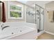 Bright bathroom featuring a separate glass shower and a soaking tub at 4619 Villa Chase Ne Dr, Marietta, GA 30068