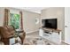 Comfortable bonus room with a large window, modern TV stand, and stylish decor at 4619 Villa Chase Ne Dr, Marietta, GA 30068