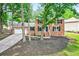 Front exterior of brick house with black shutters, a driveway and a front lawn with trees at 4619 Villa Chase Ne Dr, Marietta, GA 30068