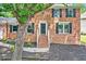 Charming brick home featuring a front porch and a professionally landscaped yard at 4619 Villa Chase Ne Dr, Marietta, GA 30068