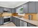 Modern kitchen featuring gray cabinets, stainless steel appliances, and sleek countertops at 4619 Villa Chase Ne Dr, Marietta, GA 30068