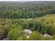 Expansive aerial view of the property showcasing the lush surrounding forest and nearby golf course at 570 Matterhorn Way, Alpharetta, GA 30022