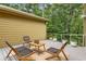 Outdoor deck with seating area surrounded by lush greenery, perfect for relaxing or entertaining at 570 Matterhorn Way, Alpharetta, GA 30022