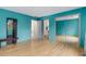 Inviting bedroom with a large mirror closet, bench, and wood-look flooring at 570 Matterhorn Way, Alpharetta, GA 30022
