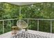 Cozy, covered deck provides a serene escape with nature views and relaxed seating at 570 Matterhorn Way, Alpharetta, GA 30022