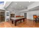 Spacious game room with pool table, fireplace, terracotta floors, and wine storage at 570 Matterhorn Way, Alpharetta, GA 30022