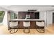 Modern kitchen features a large island with marble countertop and three bar stools at 570 Matterhorn Way, Alpharetta, GA 30022