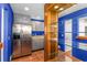 Modern bar area with stainless steel appliances and blue accent walls at 570 Matterhorn Way, Alpharetta, GA 30022