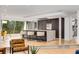 Bright, open kitchen with stainless steel appliances, marble island, and breakfast bar seating at 570 Matterhorn Way, Alpharetta, GA 30022