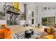 Bright living room featuring a stone fireplace, modern staircase, and large windows overlooking a landscaped yard at 570 Matterhorn Way, Alpharetta, GA 30022