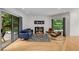 Modern living room with hardwood floors, stylish furniture, and sliding door to deck at 570 Matterhorn Way, Alpharetta, GA 30022