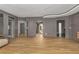 Large living room with hardwood floors, recessed lighting, and multiple entryways for seamless movement at 570 Matterhorn Way, Alpharetta, GA 30022
