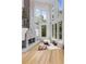 Bright living room featuring a stone fireplace and large windows overlooking a landscaped yard at 570 Matterhorn Way, Alpharetta, GA 30022