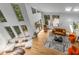 Bright living room featuring a fireplace, modern furniture, and large windows overlooking a landscaped yard at 570 Matterhorn Way, Alpharetta, GA 30022