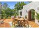 Spacious outdoor patio features terracotta tiles, dining area, and lush landscaping for outdoor living at 570 Matterhorn Way, Alpharetta, GA 30022