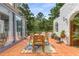 Exterior patio with terracotta tile, dining set, and lush greenery at 570 Matterhorn Way, Alpharetta, GA 30022