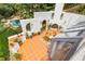 Expansive patio with terracotta tile, outdoor dining, fireplace, potted plants, and greenery at 570 Matterhorn Way, Alpharetta, GA 30022