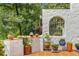 Charming outdoor patio adorned with potted plants and arched window overlooking the surrounding greenery at 570 Matterhorn Way, Alpharetta, GA 30022