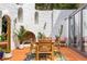 Covered patio featuring terracotta tile, dining set, outdoor fireplace and greenery at 570 Matterhorn Way, Alpharetta, GA 30022