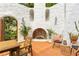 Charming patio features terracotta tile, outdoor fireplace, seating, and greenery at 570 Matterhorn Way, Alpharetta, GA 30022