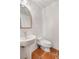 Well-lit powder room with sleek pedestal sink and low flow toilet at 570 Matterhorn Way, Alpharetta, GA 30022
