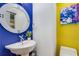 Stylish powder room with modern fixtures, unique mirror, and bright color palette at 570 Matterhorn Way, Alpharetta, GA 30022