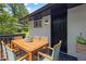 Charming back porch with dining table, seating, plants and whitewashed brick on the back of the home at 1733 Hollyhock Ter, Decatur, GA 30032