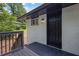 Backyard entrance to home from deck, with a black door and painted brick exterior at 1733 Hollyhock Ter, Decatur, GA 30032