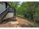 A backyard view from deck stairs surrounded by foliage and landscape at 1733 Hollyhock Ter, Decatur, GA 30032