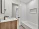 An updated bathroom featuring modern fixtures, a tub, and a wood vanity at 1733 Hollyhock Ter, Decatur, GA 30032