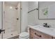This new bathroom features modern fixtures, a wood vanity, and a stand up shower at 1733 Hollyhock Ter, Decatur, GA 30032