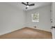 A bright bedroom features light-colored hardwood floors, a ceiling fan, and natural light from the window at 1733 Hollyhock Ter, Decatur, GA 30032