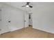 This bedroom features light-colored hardwood floors, a ceiling fan, and two entry doors at 1733 Hollyhock Ter, Decatur, GA 30032
