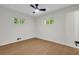 Bedroom features wood-look floors, ceiling fan, and bright windows at 1733 Hollyhock Ter, Decatur, GA 30032