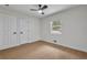 A bright bedroom features light-colored hardwood floors, a ceiling fan, and natural light from the window at 1733 Hollyhock Ter, Decatur, GA 30032