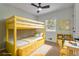 Bright bedroom featuring a yellow bunk bed, ceiling fan and a window providing natural light at 1733 Hollyhock Ter, Decatur, GA 30032