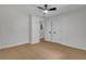This bedroom features light-colored hardwood floors, a ceiling fan, and two entry doors at 1733 Hollyhock Ter, Decatur, GA 30032