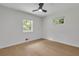 A bright bedroom features light-colored hardwood floors, a ceiling fan, and natural light from the window at 1733 Hollyhock Ter, Decatur, GA 30032