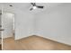 An empty bedroom features light-colored hardwood floors, a ceiling fan, and an en suite bath at 1733 Hollyhock Ter, Decatur, GA 30032