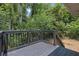 A backyard view from a deck and railing surrounded by lush greenery at 1733 Hollyhock Ter, Decatur, GA 30032