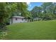 Exterior view of home with a lush green lawn and mature trees in the background at 1733 Hollyhock Ter, Decatur, GA 30032
