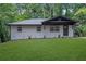 Stylish home exhibiting a well-kept lawn, and sleek, painted brick at 1733 Hollyhock Ter, Decatur, GA 30032