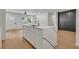 Modern kitchen island features a white countertop, sink and views of the dining area with hardwood floors at 1733 Hollyhock Ter, Decatur, GA 30032