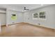 Bright, open living area with hardwood floors, windows, a ceiling fan, and a freshly painted white walls at 1733 Hollyhock Ter, Decatur, GA 30032