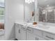 Bright bathroom featuring double vanity with white cabinets, quartz countertop, and large mirror at 206 Maycrest Path, Tucker, GA 30084