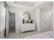Bedroom view with white dresser, round mirror and entry to en-suite bathroom at 206 Maycrest Path, Tucker, GA 30084
