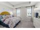 Well-lit bedroom with tray ceiling, two windows, and colorful floral patterned bedding at 206 Maycrest Path, Tucker, GA 30084